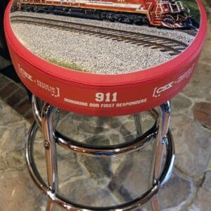 Red bar stool depicting train and 911
