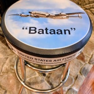 Barstool top featuring "Bataan" Air Force plane