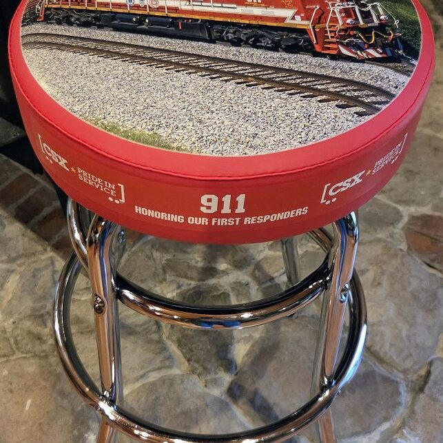 Red bar stool depicting train and 911
